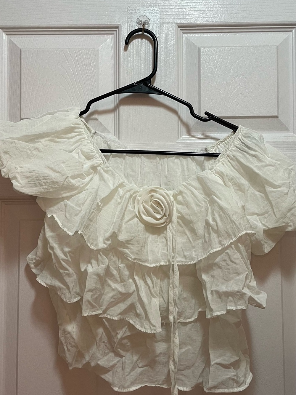 Women’s White Ruffled Off-Shoulder Top with Floral Accent